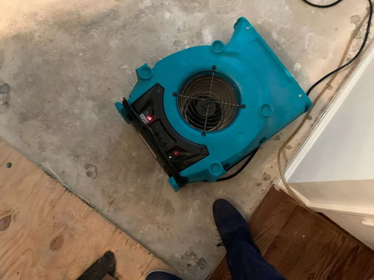 Air mover drying subfloor during Leak Detection & Repair in Upper Macungie